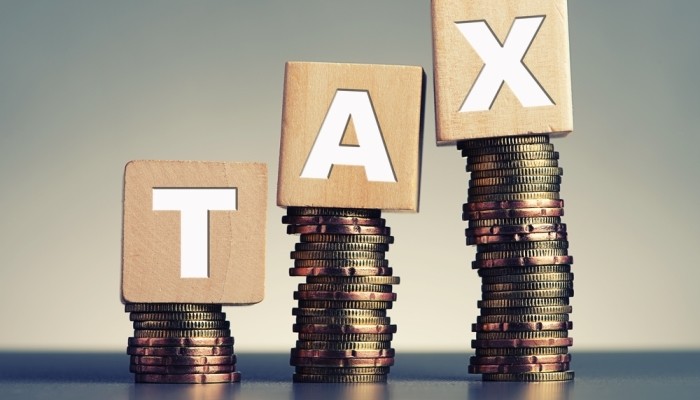 Tax Wooden Blocks On Stacked Coins