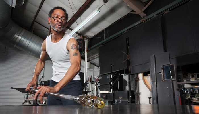 Glass artisan focusing on his work