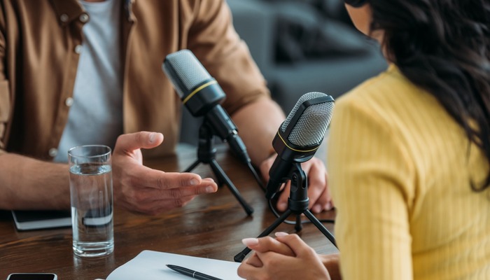 Two people recording a podcast