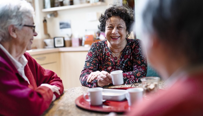 Three baby boomers drinking tea