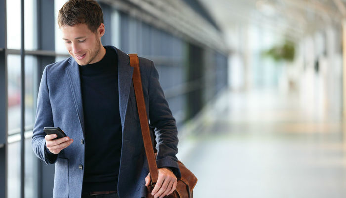 Business owner checking his business apps at the airport
