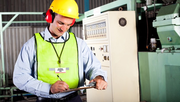 Worker performing risk assessment in the workplace