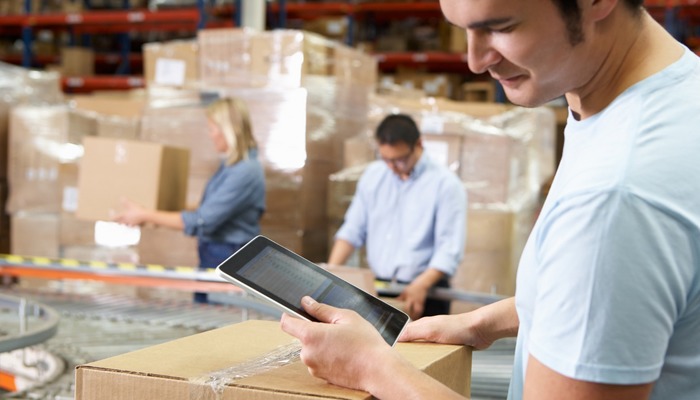 Workers packaging boxes in a warehouse