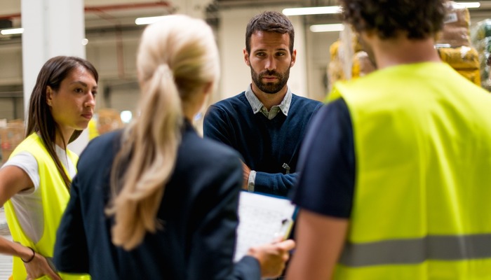 Warehouse and office workers having a meeting