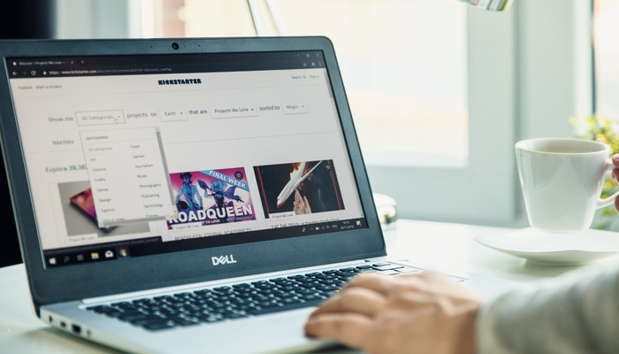 Modern laptop on the desk in office with Kickstarter website on the screen.